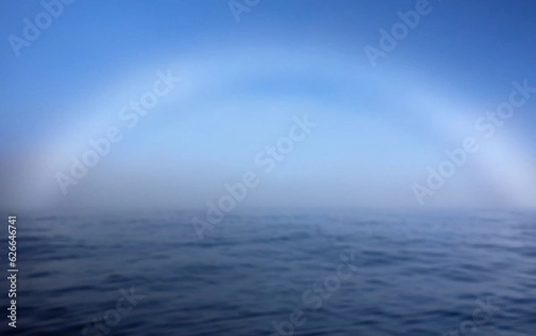 Fototapeta A fogbow over Arctic Ocean near North Cape in Northern Norway on late summer day in August 2022.