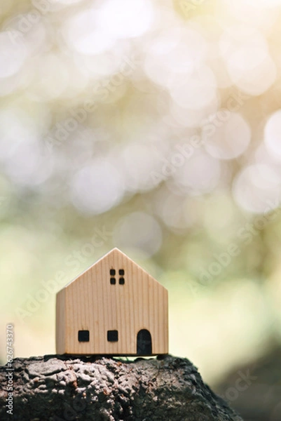 Fototapeta close up toy wooden house on wood, saving and manage to success business, home insurance technology, subprime mortgage crisis risk and problem concept
