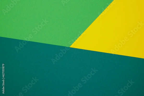 Fototapeta Multicolor background from a paper of different colors. Mix of yellow, green and dark green colors. Geometric backdrop.