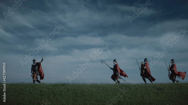 Fototapeta Four Roman soldiers come out to attack in the evening in open territory.