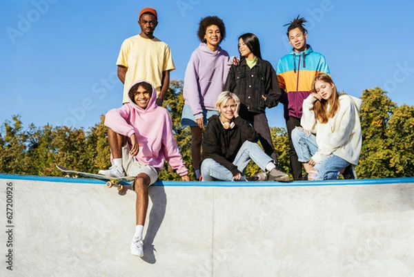 Fototapeta Multiracial group of young friends bonding outdoors