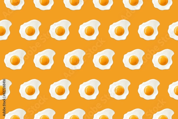 Fototapeta Fried eggs on a yellow background. Seamless pattern with scrambled eggs. Vector illustration of eggs. Realistic image.