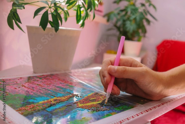 Obraz diamond mosaic intermediate fragment of the picture close-up on a light table in the room selective focus