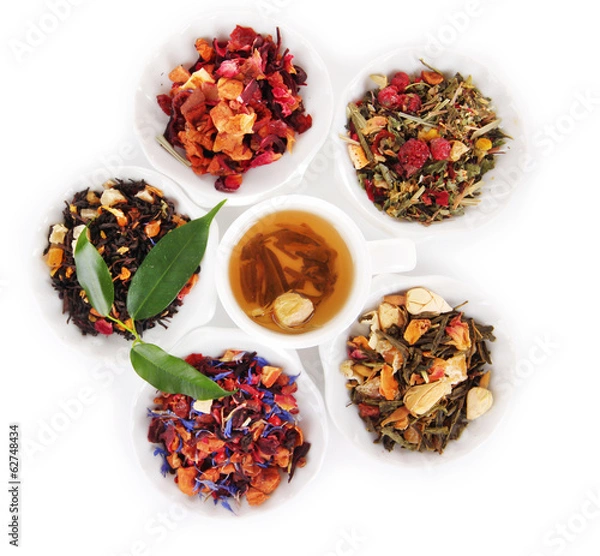 Fototapeta Cup of tea with aromatic dry tea in bowls isolated on white
