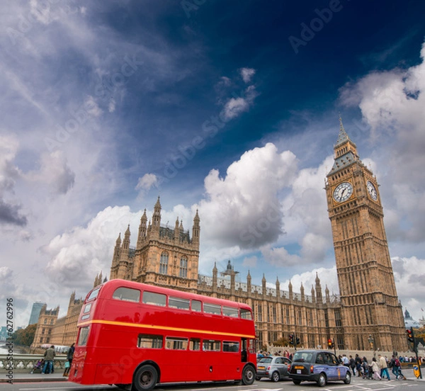 Obraz Red bus on Westminster Bridge under a dramatic sky - London