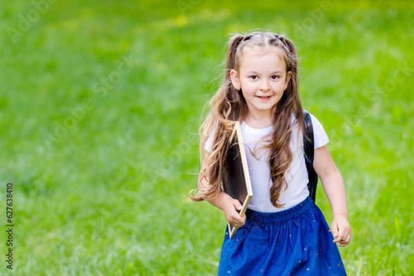 Fototapeta Back to school and happy times.Girl with backpack and drawing board. 