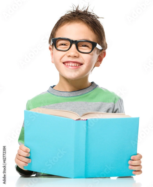 Obraz Little boy is reading a book