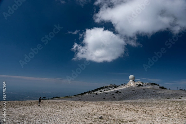 Obraz The top of the Mont Ventoux in Vaucluse,  a man takes readings near the Radôme, a civil aviation radar. A blue sky.