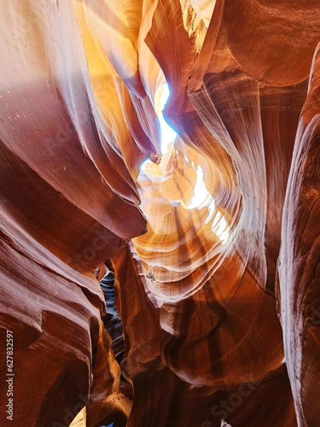 Fototapeta photo of antelope canyon on the navajo reservation. warm light filtering through the rocks, creating beautiful orange, red and yellow colors. Signs of rock erosion caused by water and wind