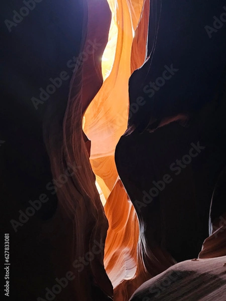 Fototapeta photo of antelope canyon on the navajo reservation. warm light filtering through the rocks, creating beautiful orange, red and yellow colors. Signs of rock erosion caused by water and wind