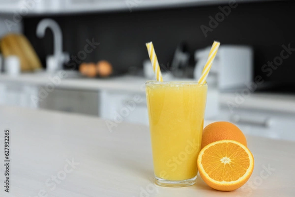 Fototapeta Fresh orange juice on the kitchen table