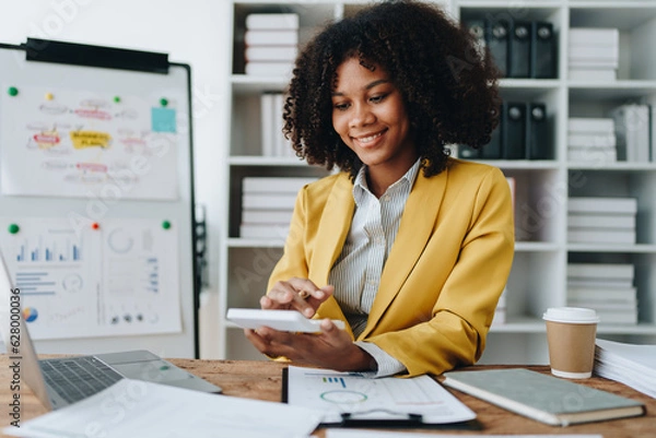 Obraz Young asian female work with financial papers at home count on calculator before paying taxes receipts online, planning budget glad to find chance for economy saving money, audit concepts.