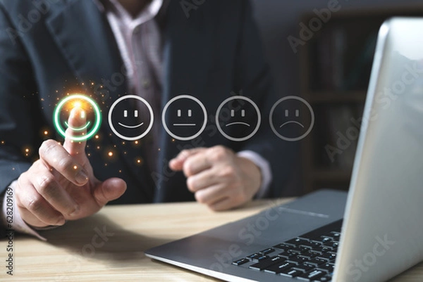 Fototapeta a businessman choose the virtual screen on the happy smile face icon to give satisfaction in service.rating very impressed.customer review service and Satisfaction concept