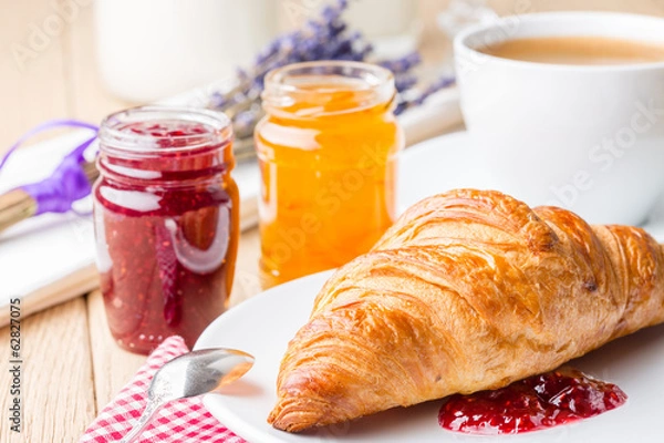 Obraz Croissants with raspberry and orange jam.
