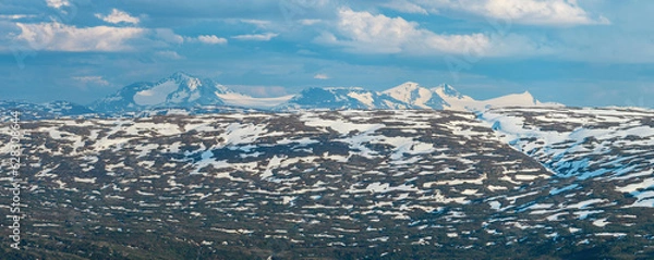 Fototapeta View from the peak of Hauknestinden, Mo i Rana, Helgeland, Norway, looking south towards Okstindan, the tallest mountain in Nord-Norge. Snow capped mountains in summer scandinavia. Panorama, hiking