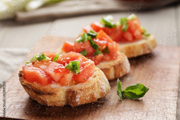 Fototapeta simple italian appetizing bruschetta with tomato