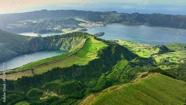 Fototapeta Flying over Lagoa das Sete Cidades lake in sunny day. Sao Miguel Island, Azores, Portugal. Lakes in the craters of extinct volcanoes surrounded by green vegetation