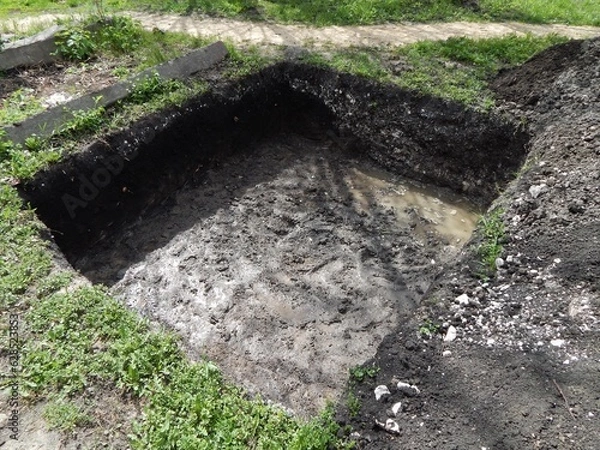Obraz Deep square trench.. A hole dug for a foundation. 