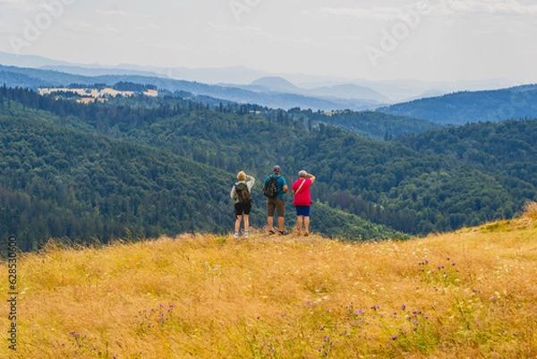 Obraz People looking from the top of the Ochodzita mountain to the Beskidy Mountains.
