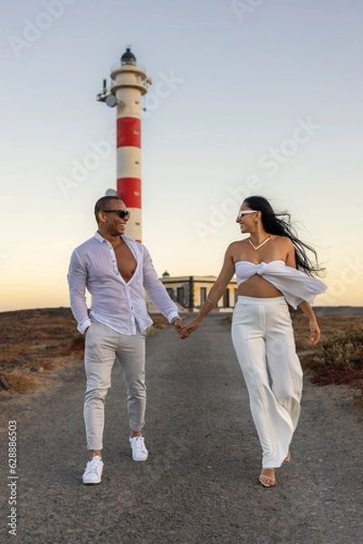 Obraz Pareja paseando por la carretera del faro