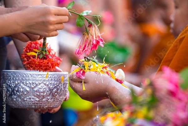 Fototapeta People pouring water to Buddhist monks and gives blessing in Thailand Songkran annual festival in Buddhist temple