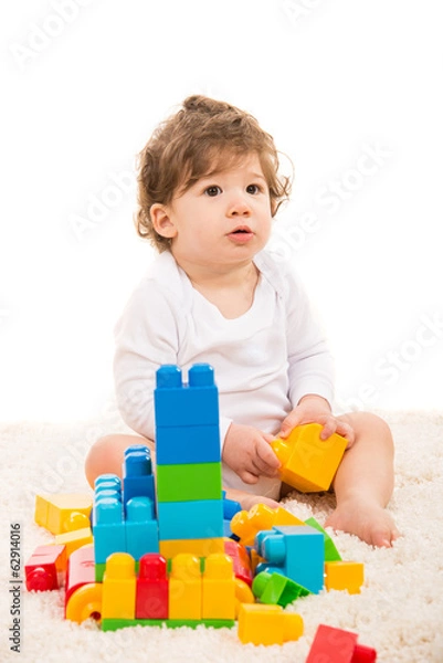 Fototapeta Baby boy playing with building blocks