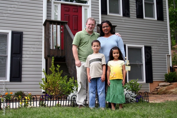 Obraz A family standing in front of their home