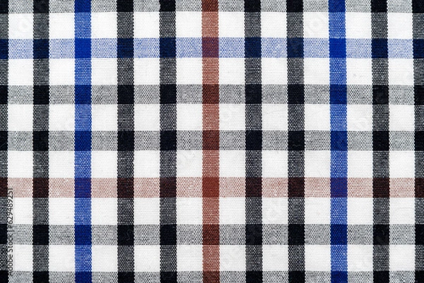 Obraz The texture of linen fabric in a large cell of black, blue and white. Scottish tailoring material. checkered fabric