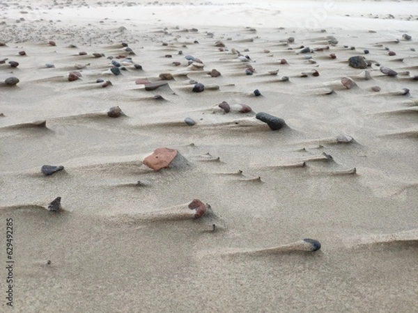 Obraz Beach sand with stones in the wind with strange shapes