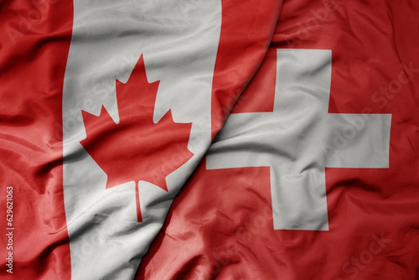 Obraz big waving realistic national colorful flag of canada and national flag of switzerland .