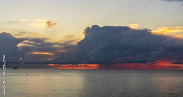 Obraz Cumulonimbus at dawn with reddish sky.