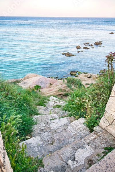 Fototapeta Stone stair leading down to the beach on the mediterranean coast of Spain.