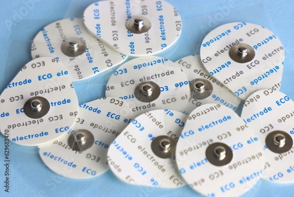 Fototapeta Ecg (eletrocardiogram) electrode in a light blue background 