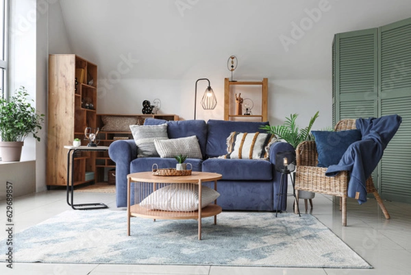 Fototapeta Interior of stylish living room with glowing lamps, sofa and armchair
