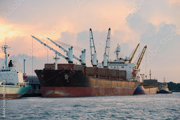 Obraz Cargo ship loading containers at sunshine