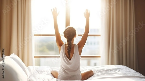 Fototapeta Attractive Woman Embraces the Sunlight, Stretching and Relaxing on White Bed Sheets in a Hotel Room. Generative AI