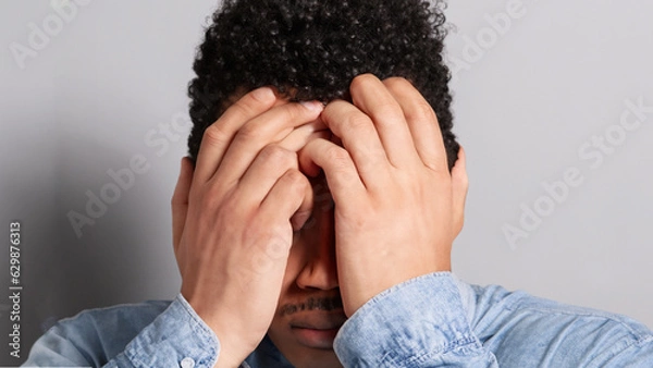 Obraz man covering his face with hands