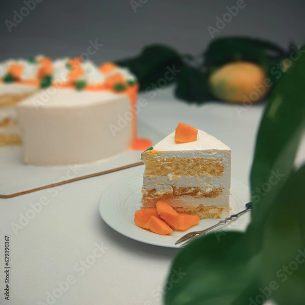 Obraz Delicious mango fruit cake on white surface