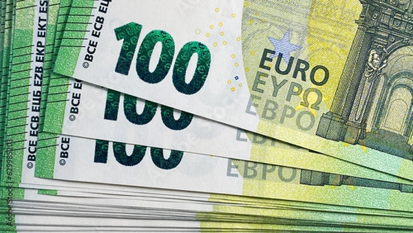 Fototapeta 100 euro bills. Top view of a stack of hundred Euro notes. Close-up. The single currency of the European Union. Cash banknotes. European currency. Background of money.