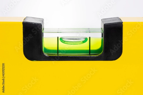 Fototapeta closeup of spirit level tool in yellow isolated on white background