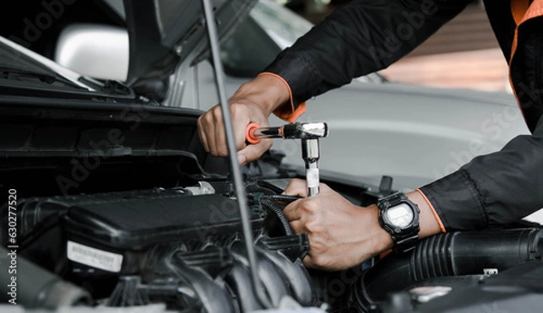 Fototapeta Mechanic fixing a car at home. Repair and service.