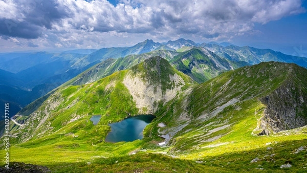 Fototapeta The Capra Lake. Summer landscape of the Fagaras Mountains, Romania. A view from the hiking trail near the Balea Lake and the Transfagarasan Road.