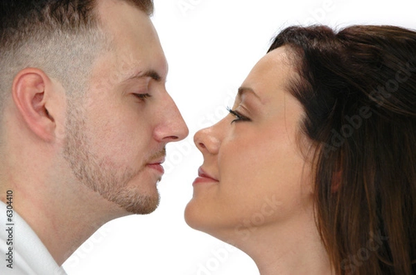 Obraz Young couple looking at each other isolated on white