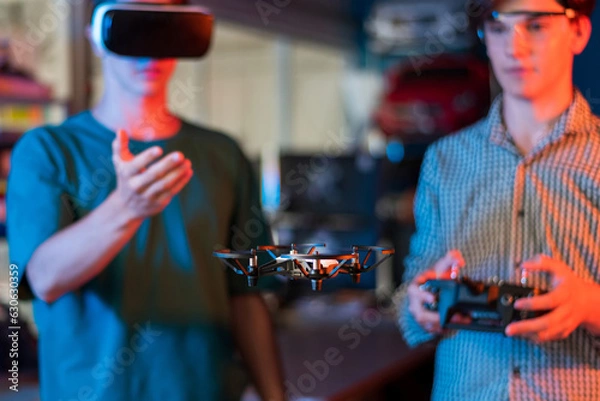 Fototapeta Teens remotely controlling robots in a laboratory