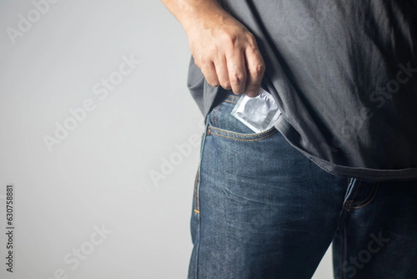 Obraz The man pulled out a condom from his pants pocket and stood there.