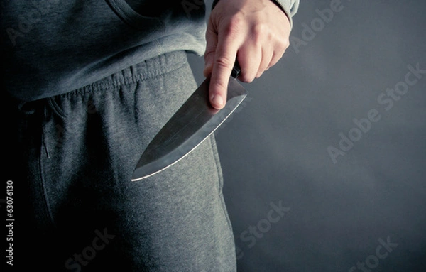 Fototapeta Robber thrusting a knife