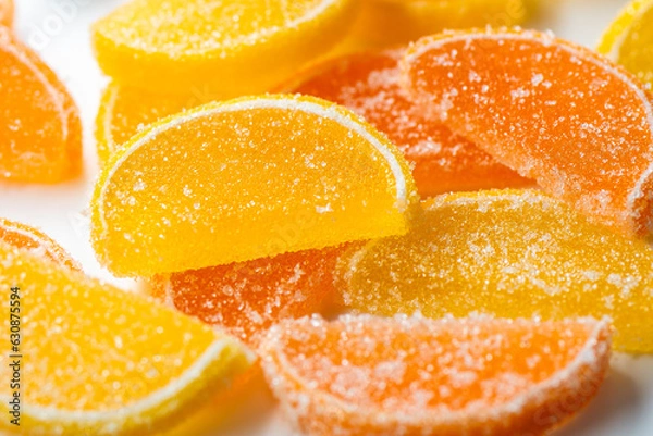 Fototapeta Marmalade lemon slice sprinkled with sugar, on a white background, macro.