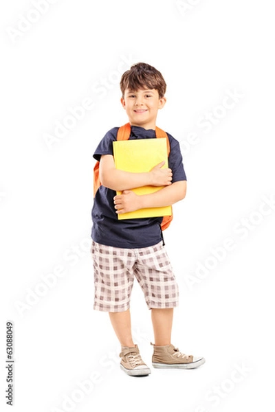 Fototapeta Schoolboy with backpack holding a notebook