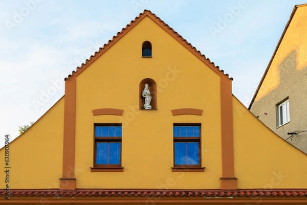 Fototapeta Ancient sculptures in the architecture of the city. Historical and cultural heritage. Background.