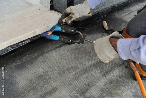 Fototapeta Man applying waterproof coating